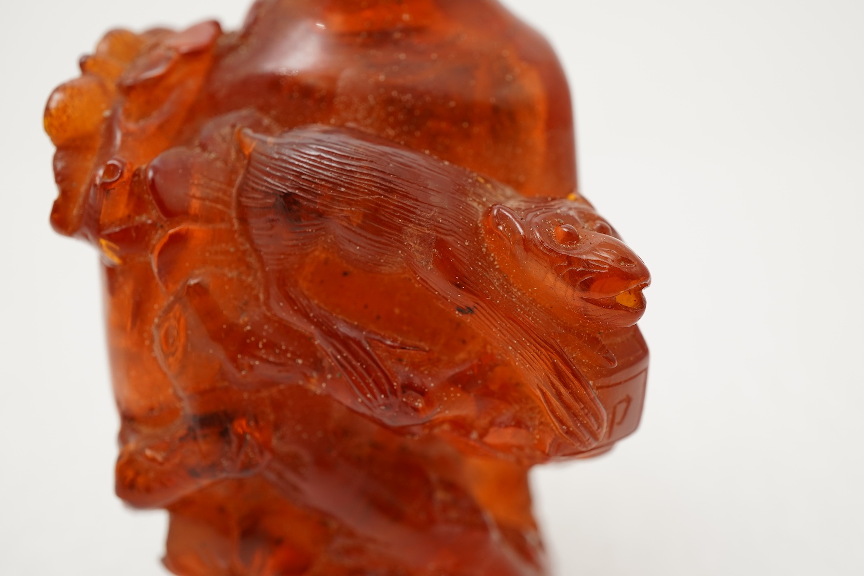 A Chinese caved amber snuff bottle, 19th century